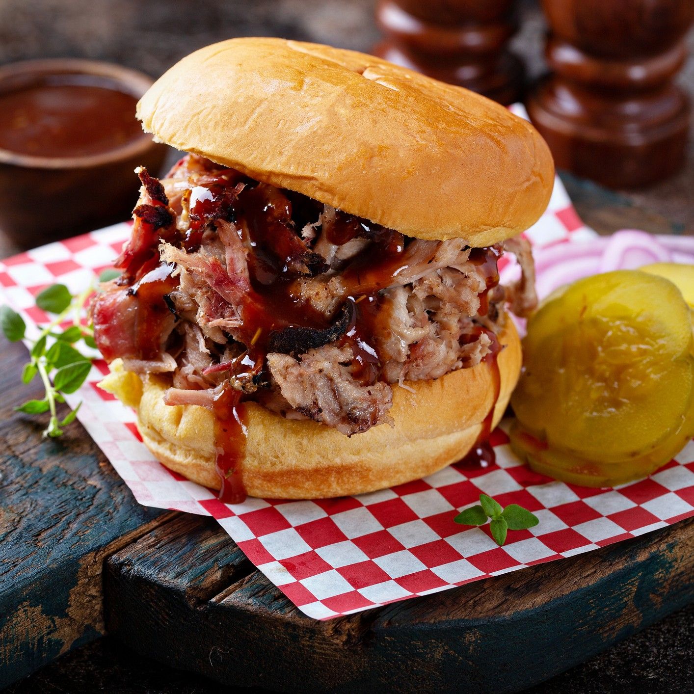 Brisket sandwich on a checkered napkin.