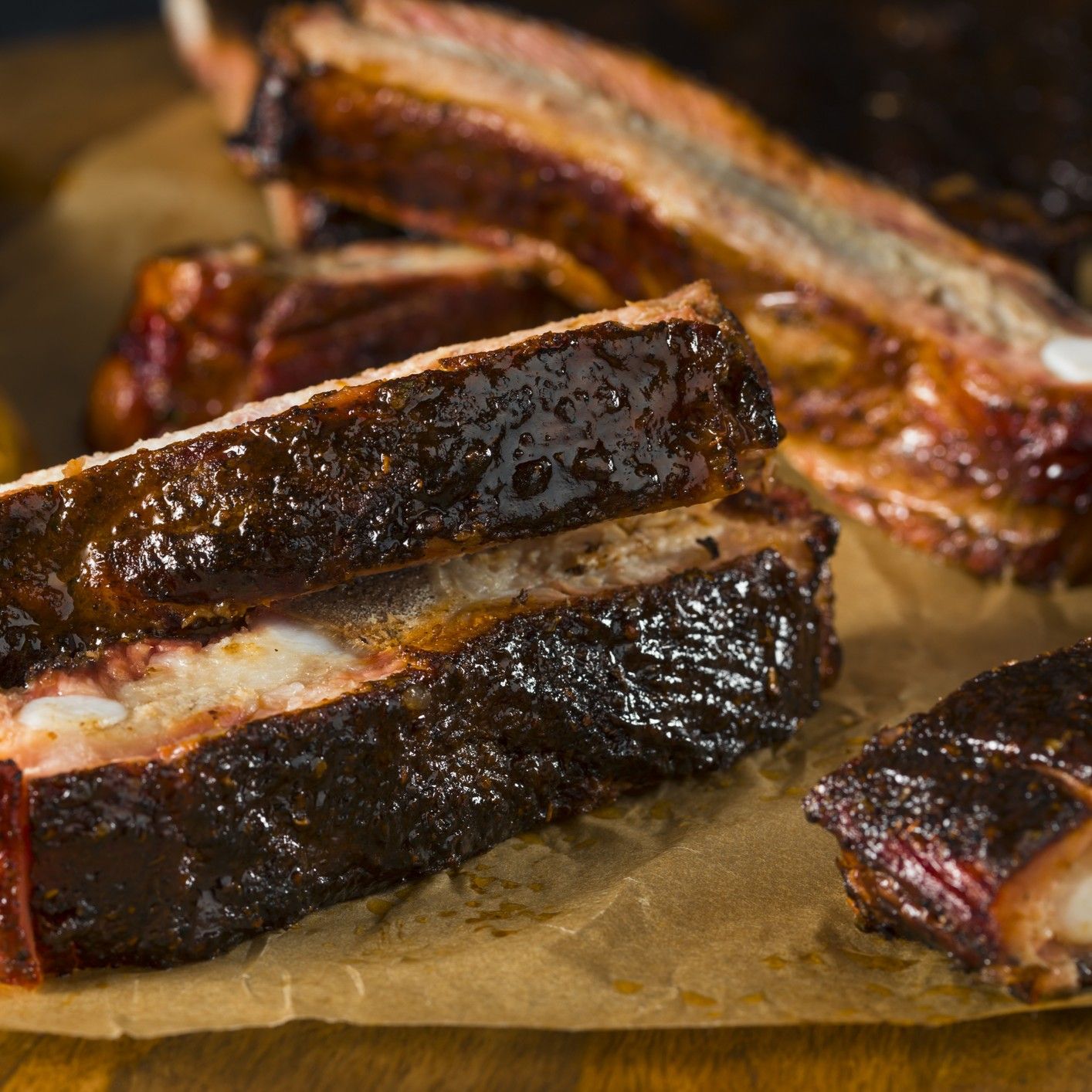 Barbecued ribs on a wood cutting board.